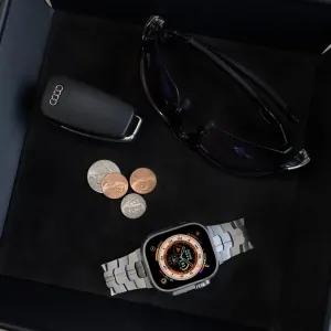 Just Mobile -titaaniranneke Apple Watch Ultra -kellolle, esiteltynä kelloon kiinnitettynä mustassa esittelyrasiassa