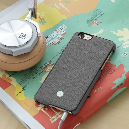Gray leather case for iPhone 6s Plus with embossed back, slim profile and cutouts for camera, buttons and headphone port.