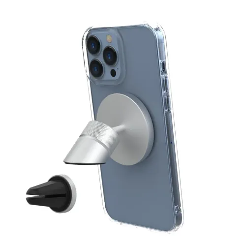 Metallinen autokiinnike, jossa on pyöreä levy ja uritettu kiinnike, joka kiinnitetään puhelimen takaosaan, irtonaisen mustan venttiiliklipsin viereen.