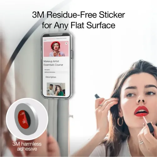 MagSafe compatible iPhone wall mount holds phone vertically on mirror; holder behind, person putting on makeup.