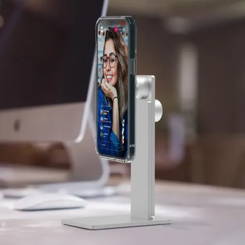 Just Mobile AluDisc Pro iPhone stand in silver with L-shaped base and two grooved knobs, holds the iPhone vertically on the table.