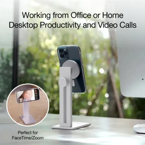 Aluminum iPhone stand with round magnetic plate, height track and knob on pillar and square base on desk next to screen.